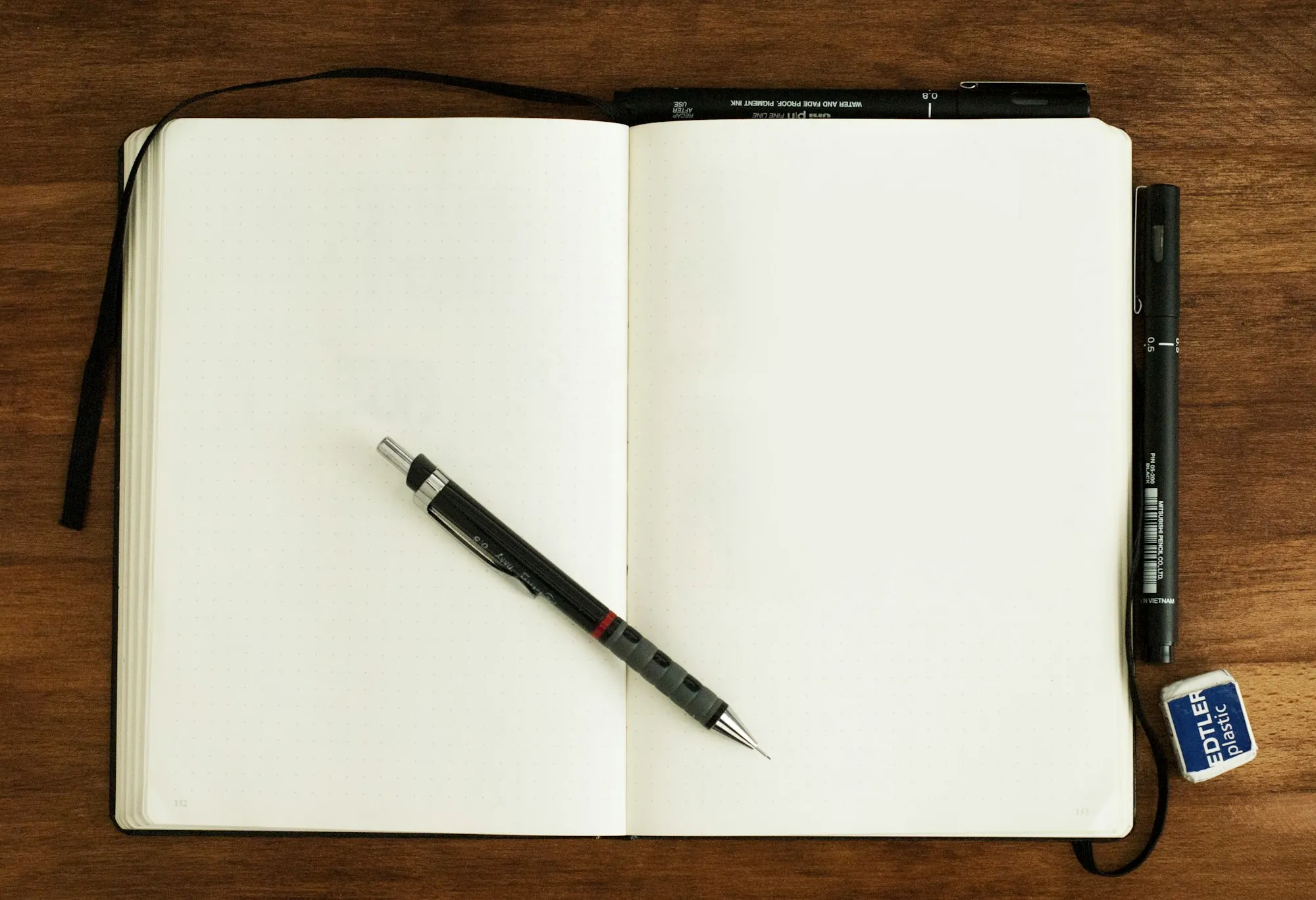 Open notebook with a mechanical pencil